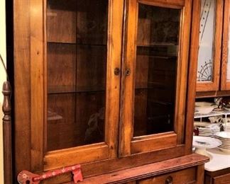 This antique cabinet has been used for shelving, display, and storage in the kitchen.