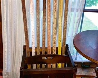 Vintage magazine rack w/ advertising yard sticks, some are SOLD