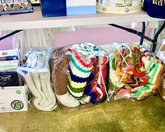 Hand stitched afghans, plastic and cloth table linens