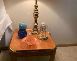 Two end tables with matching coffee table, two brass lamps, miscellaneous glassware
