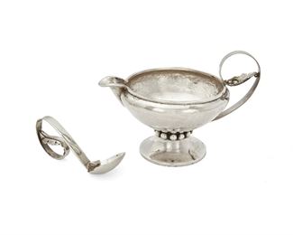 60
A Los Castillo Silver Sauce Bowl And Ladle
Circa 1948-1955; Taxco, Mexico
Each marked: Los Castillo / Taxco / Handwrought / Eagle 15 / Sterling / Mexico; Bowl numbered: 101; Ladle numbered: 119
The hand-hammered sterling silver bowl with scrolled foliate motif handle, spout, and flared foot with applied buttons, with conformingly decorated ladle, 2 pieces
Bowl: 4.125" H x 6.5" W x 4.25" D
10.01 oz troy approximately
Estimate: $400 - $600