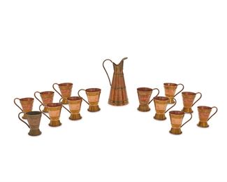 63
A Hector Aguilar Copper And Brass Drink Set
Circa 1940; Taxco, Mexico
Each marked for Hector Aguilar; Further marked: Taxco / Mexico; Seven numbered: 994
Comprising a pitcher and twelve matching cups, each designed with a copper body with brass straps, 13 pieces
Pitcher: 12.25" H x 6.5" W x 5.75" D; Each cup: 5.5" H x 5.5" W x 3.75" D
Estimate: $400 - $600