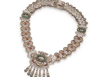 81
A Matl Silver And Gem-Set Necklace
Circa 1934-1948; Mexico City, Mexico
Stamped: Matl / Mexico / 925
Designed by Matilde Poulat, the scrolled links issuing a central pendant suspending fringe, set with coral and turquoise cabochons
15.25" L x 2.25" H
85 grams
Estimate: $1,000 - $1,500