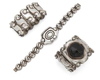 84
Three Matl Silver Bracelets
Circa 1940; Mexico City, Mexico
Stamped: Matl
Each designed by Matilde Poulat, comprising a bracelet centering an onyx mask flanked by Aztec-inspired links (6" L x 2" H), a repousse link bracelet of eleven scroll links (7.5" L x .4" H), and a repousse linked bracelet centering a swirled plaque (7.5" L x 1" H), 3 pieces
183 grams gross
Estimate: $1,000 - $1,500