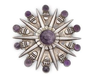 91
A William Spratling Silver And Amethyst Pendant/Brooch
Circa 1940-1946, First Design Period; Taxco, Mexico
Stamped for William Spratling; Further stamped: Made in Mexico / Silver
Designed as an Aztec sunburst inset with eleven cabochon amethyst
3" Dia.
82 grams
Estimate: $1,000 - $1,500