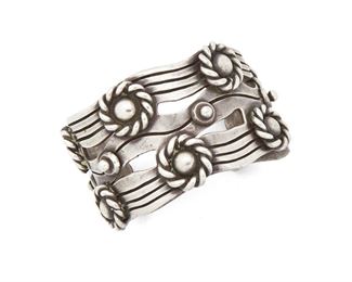 93
A William Spratling "River Of Life" Silver Cuff
Circa 1940-1946, First Design Period; Taxco, Mexico
Stamped for William Spratling; Further stamped: Made in Mexico / Silver
Designed as silver waves with roped Aztec rings
7.5" L x 2" W, wrist opening: 1.5"
177 grams
Estimate: $1,000 - $2,000