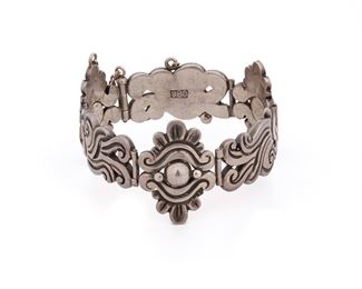 96
A William Spratling Silver Bracelet
Circa 1933-1939, First Design Period; Taxco, Mexico
Stamped for William Spratling; Further stamped: Taxco / 980
Composed of an Aztec-motif motifs
7" L x 1.25" W
82 grams
Estimate: $600 - $800
