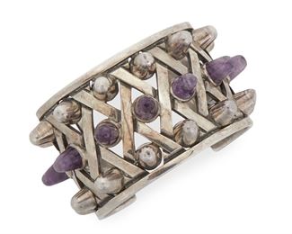 123
An Antonio Pineda Sterling Silver And Amethyst Cuff Bracelet
Circa 1953-1979; Taxco, Mexico
Crown mark for Antonio Pineda; Further stamped: Eagle 17 / Hecho en Mexico / 970 / Silver
The rigid cuff with silver latticework design interspersed with 'spiked' silver and amethyst domes
6.5" C x 1.75" W, wrist opening: 1.25"
129 grams
Estimate: $2,000 - $3,000