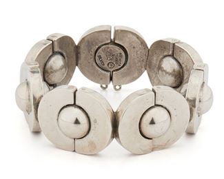 151
An Antonio Pineda Silver Bracelet
Circa 1953-1979; Taxco, Mexico
Crown mark for Antonio Pineda; Further stamped: Eagle 17 / Hecho en Mexico / Silver
Designed with polished half circle links centering silver spheres
7.5" C x 1" W
130.5 grams
Estimate: $600 - $800