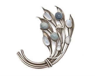170
An Antonio Pineda Sterling Silver And Multi-Gemstone Brooch
Circa 1953-1979; Taxco, Mexico
Crown mark for Antonio Pineda; Further stamped: Eagle 17 / Hecho en Mexico / 970
Designed as an abstract wheat sheaf brooch set with oval cabochon moonstone and speckled blue/green stones
3.75" L x 3" W
42 grams
Estimate: $500 - $700