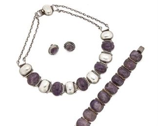 189
An Assembled Suite Of Fred Davis Silver And Amethyst Jewelry
Pre-1948; Mexico City, Mexico
Stamped: FD [Fred Davis] / Silver / Mexico
Comprising a necklace with oval silver and cabochon amethyst segments (16" L x .85" H) together with a cushion cabochon amethyst link bracelet (9" L x .85" W) and a pair of screw back earrings (.75" W), 4 pieces
171.5 grams
Estimate: $1,000 - $2,000