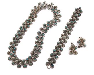 192
A Suite Of Fred Davis Silver And Turquoise Jewelry
Pre-1948; Mexico City, Mexico
Stamped: FD [Fred Davis] / Silver / Mexico; Earrings attributed to Davis
Comprising a stylized caviar link necklace set with cabochon turquoise (16" L x .75" W) en suite with a matching bracelet (6.5" L x .75" W) and a pair of screw-back earrings (1" L x .75" W), 3 pieces
117 grams
Estimate: $1,000 - $2,000