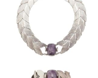 193
A Set Of Fred Davis Silver And Amethyst Jewelry
Pre-1948; Mexico City, Mexico
Stamped: FD [Fred Davis] / Made in Mexico / Silver / Mexico
Comprising a chevron link necklace featuring a large cushion shaped cabochon amethyst (13.5" L x 1" W) and a matching bracelet ( 7.5" L x 1.1" W), 2 pieces
152 grams
Estimate: $1,000 - $2,000