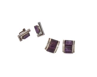 199
Two Pairs Of Mexican Silver And Amethyst Earrings
Circa 1939-1953
Stamped: Toni's Silver AP Mexico; Further stamped: AP
Comprising a pair of curved panel screw-back earrings set with three faceted amethysts (.75" L x .75" W) and a pair of "L" shaped screw-back earrings centering an elongated domed amethysts (.75" L x .5" W), 4 pieces
25.5 grams
Estimate: $400 - $600