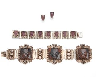 205
A Group Of Mexican Silver Jewelry
Third-quarter 20th Century
Each stamped: Mexico; One stamped: VKE / Agua / Mexico / Sterling; One stamped: Silver
Comprising a jasper bracelet (7.325" L x 1.75" H) and a silver and purple glass bracelet (5.75" L x .75" H) with matching screw-back earrings en suite (.5" H x .325" W), 4 pieces
87 grams gross
Estimate: $300 - $500