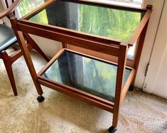 $175Mid-Century Modern bar cart with smoke glass inserts.  28.25" H, 25.5" W, 17" D. 