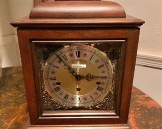 $120 Clock in wood case with metal handle.  15" H, 11" W, 7.5" D. 