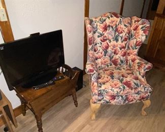 Upholstered chair and magazine rack with TV