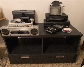 Nice dark wood media stand, retro jam box, vhs player , VHS and DVD combo player, retro cassette tape recorder