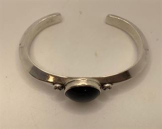 23/8” by 13/4” Cuff with black stone -quite heavy $40