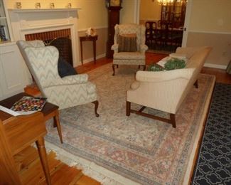 Camel back sofa. Pair of flame stitch fire side chairs. Wool oriental carpet.