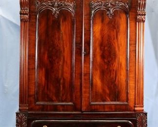069a - Unusual large crotch mahogany 2 door linen press with carving all over, pierced carved apron at base, attrib. to Anthony Quervelle, 70 in. W, 27 in. D, 8 in. T.