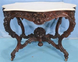 073a - Rosewood rococo marble top center parlor table attrib. to A. Roux with beautifully carved roses in basket finial and apron, 29 in. T, 42 in. L, 34 in. D.