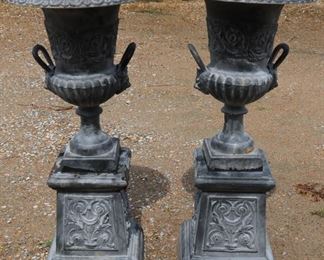 384a - Matched pair of grey cast iron urns on stand, double handle with lion heads, 41 in. T, 18 in. R.