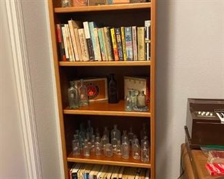 More antique bottles, great book collection, cigar boxes and a quality bookshelf.