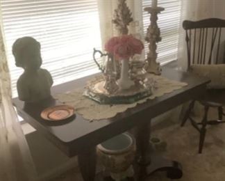 Showing the cement girl head and oriental vase on bottom shelf.