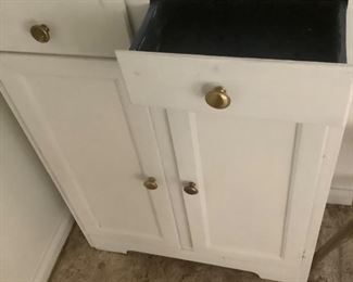 The white hand painted cabinet with blue inside, holding a lot of the white milk glass.