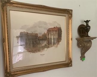 Full view of the mill with the gold wall shelf’s with black engraved vases on each shelf.