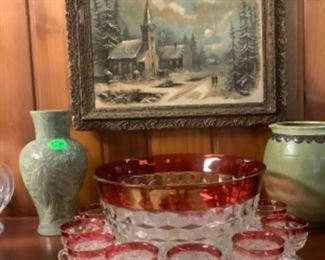 Full view of the pitcher above walnut buffet.  Red and crystal punch bowl and cups, along with some beautiful pottery.
