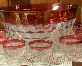 Red and crystal glass punch bowl with glass cups.