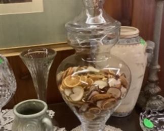 One of the tall apothecary jars on buffet with dried lemons and apple slices.