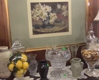 The beautiful large picture over the buffet with crystal cases, lamps, and pottery jars,