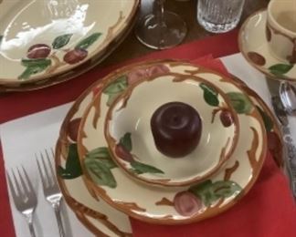 One of the place settings of the Apple dishes.  Apple in center of the bowl are used as napkin holders or name tags.
