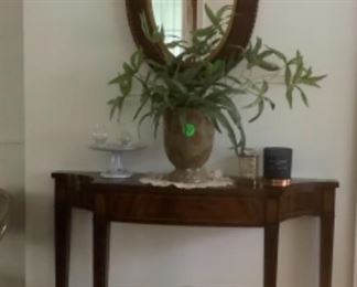 Beautiful walnut table with round mirror.  Sits flat against the wall.  Great table for small spaces.