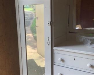 Painted white wardrobe with mirror door, mirror and lots of drawers.  Has rack for hanging clothes.  In excellent shape.