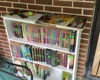 White book case with collectible books for teenagers, children and adults.