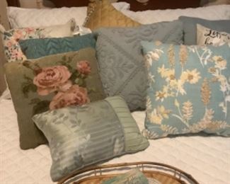 Decorative pillows on the mahogany Full size bed with mattress and box springs.