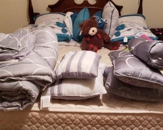 Queen bed with 4 post, headboard, foot board, pillows and comforters