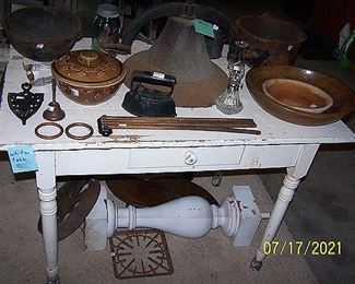 Primitive wood table, cast iron kettles, wood butter bowls, cast iron dinner bell (missing clapper), etc...