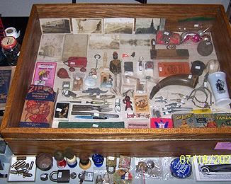 Smalls including photos of African American Siamese twins and midget, Hop-a-long Cassidy watch, Marx Zippo the climbing Monkey w/box, etc..
.