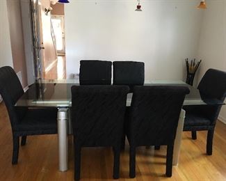 Statement making Designer Vintage glass table with 2 leaves. 6 upholstered Parsons chairs. 