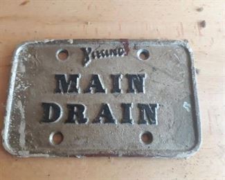 Metal main drain sign