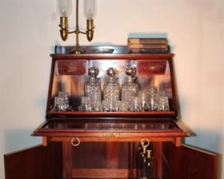 Antique Drop-front Bar with Original Crystal Showing Interior with original American Brilliant Cut Period Crystal:  (3) Decanter, (1) Highball, 5 Rocks, 4 Whiskey, 5 Shot glasses