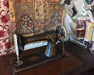 Antique Treadle Singer Sewing Machine from the early 1900’s with decorative carved detail on 6 side drawers. 