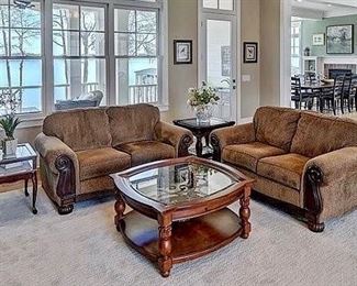 pair of matching love seats. Neutral area rug 12’x12’