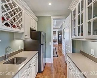 White cabinetry, granite counters, stainless sink, (refrigerator not for sale),